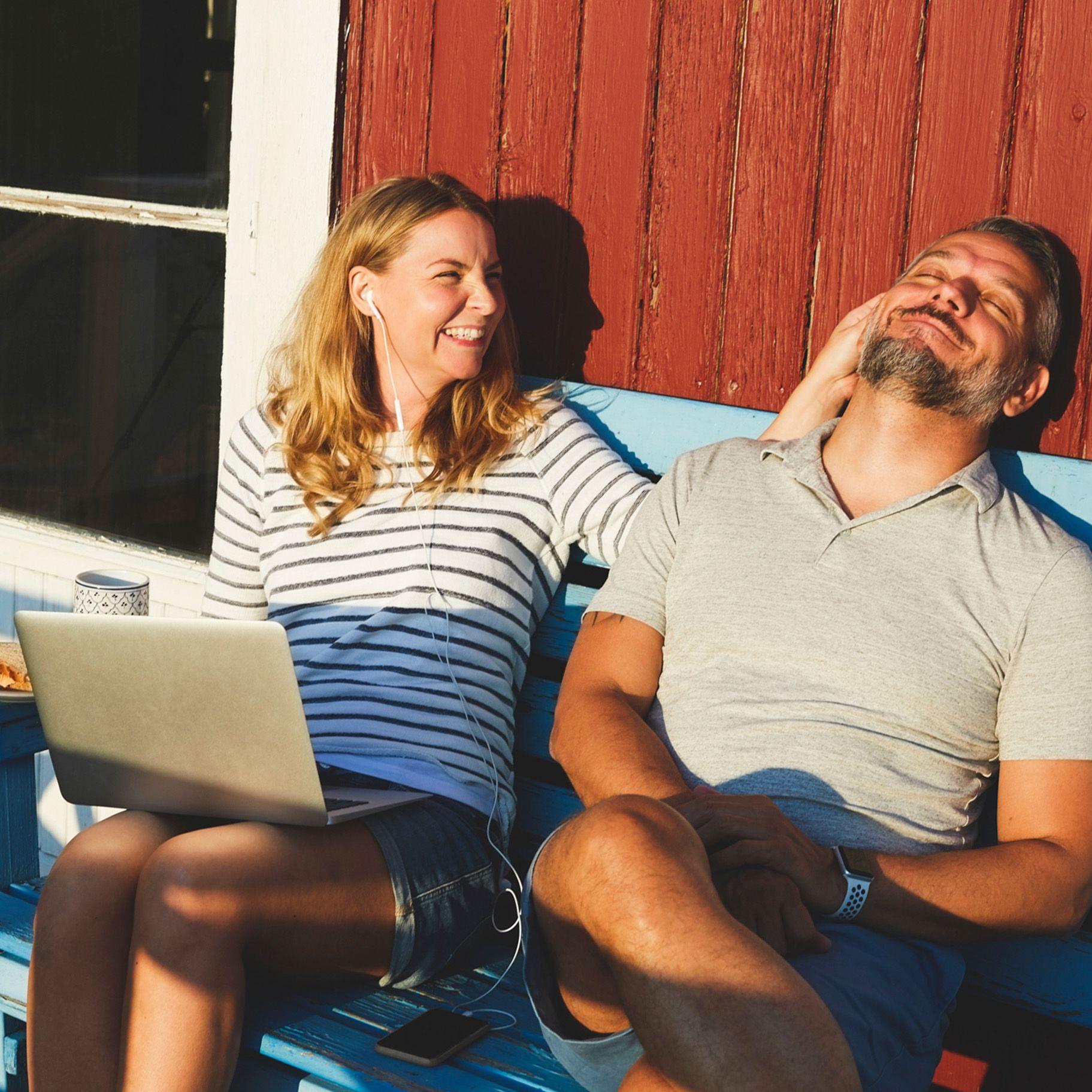 Gestiegene Nachfrage nach Fonds Frau und Mann sitzen vor dem Haus auf einer Bank in der Sonne