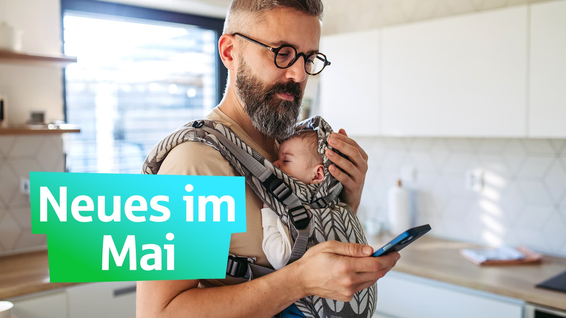 neues-im-mai-ein-mann-mit-baby-in-trage-GI-2197993172-16_9