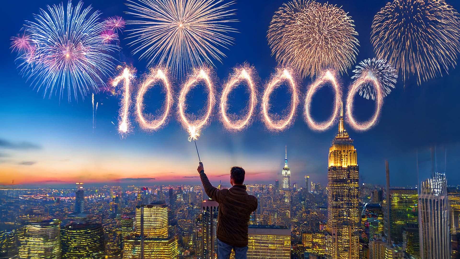 Ein Mann steht auf einem Hochhaus über einer Großstadt bei Sonnenuntergang und schreibt mit einer Wunderkerze die Zahl „1.000.000“ in den Himmel, während im Hintergrund bunte Feuerwerke den Himmel erleuchten.